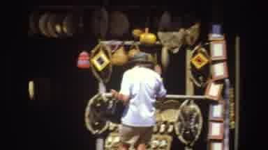 South Africa (1969): Person Walking At The Fair Going Towards A Store Making A