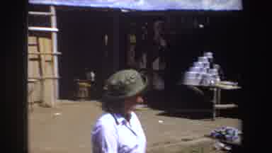 South Africa (1969): A Mature Woman Wearing A Gray Hat Walking Through A Sunny