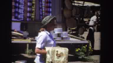 South Africa (1969): Woman Moves Around Trying To Sell Her Wares To Her Customers