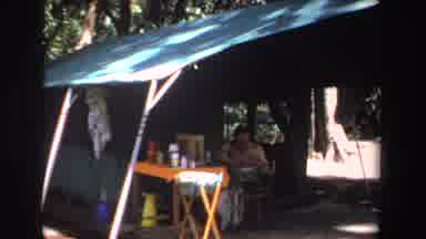 South Africa (1969): View Of Person Sitting Next To Orange Table Under Green Tent