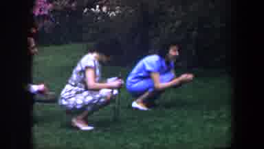 Baltimore Maryland (1960): A Couple Of Ladies Taking A Photo Of An Infant Sitting
