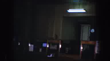 Baltimore Maryland-1960: A Dimly Lit Room With Furniture And A Fluorescent Light