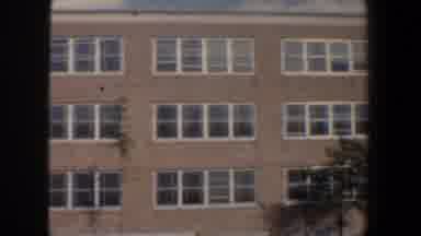 Baltimore Maryland (1960): A Three Story Brick Building On A Partly Cloudy Day