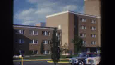 Baltimore Maryland (1960): Brick Building With Multiple Floors And Cars In The