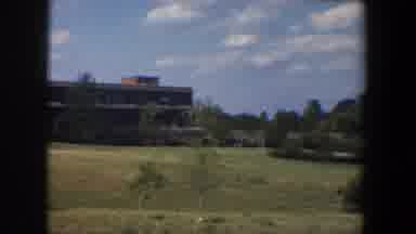 Baltimore Maryland (1960): An Empty Bushed Backyard Beside A Public Building