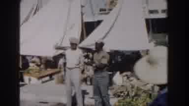 Nassau Bahamas (1961): A Group Of Workers Camping At A Site As A Car Arrives
