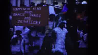 Nassau Bahamas (1961): People Wearing White Feather Costumes Carry Brown And White