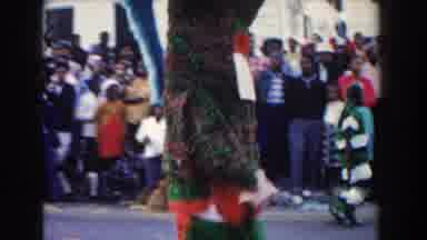 Nassau Bahamas (1961): Person Wearing Multi Colored Mascot Costume Walks Down