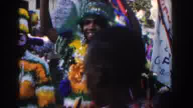 Nassau Bahamas (1961): People In Colorful Costumes March Down A Street During A