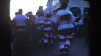 Nassau Bahamas (1961): People Wearing Pink White And Brown Costumes Walk Down