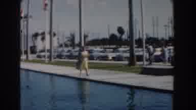 Nassau Bahamas (1961): Woman Wearing Yellow Dress Walks Blue Reflection Pool On A