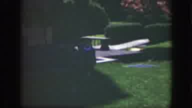 Cincinnatti Ohio (1949): A Boy Well-Dressed In A Suit Jacket Runs Across The Lawn
