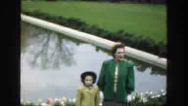 Cincinnatti Ohio (1949): An Adult And A Child Standing In A Garden In Front Of A