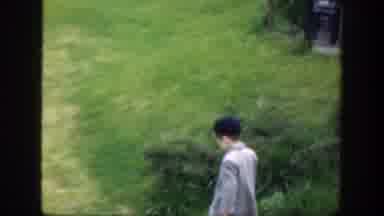 Cincinnatti Ohio (1949): Boy Wearing Gray Coat Walks Towards Reflection Pool On A