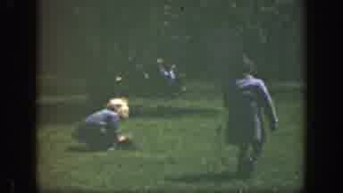 Cincinnatti Ohio (1949): A Boy And Girl Play With Adult Jackets And Hats On Grass