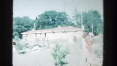 Wisconsin (1964): View Of Tan Brick Building And Green Trees On A Bright Sunny Day