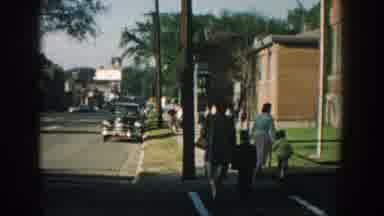 Wisconsin (1964): Woman Wearing Gray Jacket Holds Hand Of Boy Wearing Black