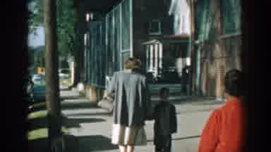 Wisconsin (1964): Woman And Little Boy Taking A Walk Holding Hands In A Quiet Town