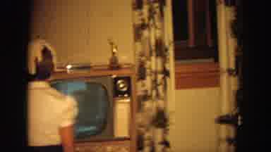 Wisconsin (1964): Girl Wearing White Shirt Stands In Front Of Tan Television Set