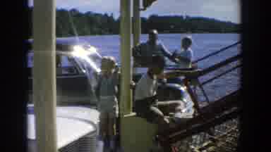 Wisconsin (1964): Young Children Sailing On A Ship While Adults Are Seen Walking