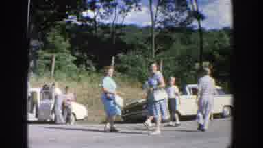 Wisconsin (1964): Off-Screen Person Picks Blueberries While People Walk To Parked