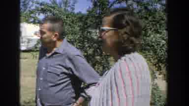 Wisconsin (1964): People Talking In A Field Among Greenery Looking Around