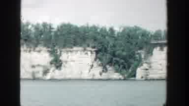 Wisconsin (1964): View Of White Stone Wall Green Ivy And Blue Water On A Clear Day