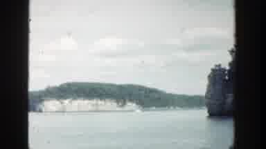 Wisconsin (1964): Island Like Rock Formations Covered In Trees Above A Body Of