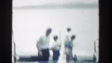 Wisconsin (1964): Three People Standing Near A White House And Green Tree On A