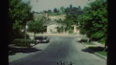 Woodland Hills California (1969): Car Driving Down Residential Street