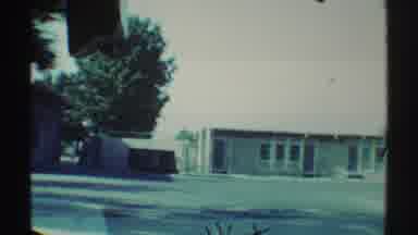 Woodland Hills California (1969): Passing View Of Green Trees And Empty School