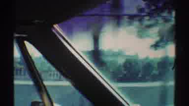 Woodland Hills California (1969): Driving A Car Past A Park During The Day Showing