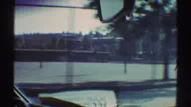 Woodland Hills California (1969): Car Driven By Newspaper Reader Passes School