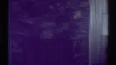 Woodland Hills California-1969: A Dimly Lit Room With Stone Fireplace and Lamp