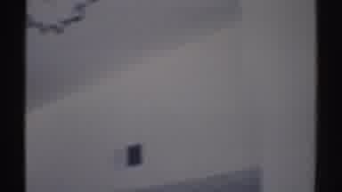 Woodland Hills California (1969): Man Wearing Brown Shorts Stands In White Living