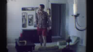 Woodland Hills California (1969): Man Standing In His Living Room With A Long