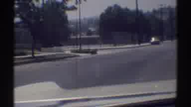 Woodland Hills California (1969): Driving In A Car By A Large Fenced In Property