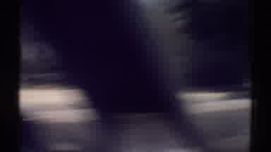 Woodland Hills California (1969): Car Driving On Road Past House On A Sunny Day