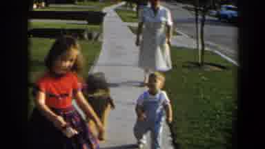 California (1958): A Woman With Two Kids And A Dog Are Walking On Footpath