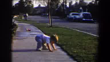 California (1958): A Small Child Getting Up And Walking On The Sidewalk