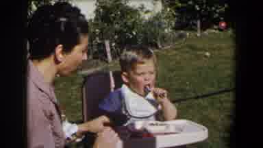 California (1958): Little Boy Having Lunch With His Mother In The Garden