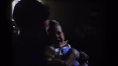 California (1958): A Woman Cuddles And Laughs With Her Baby In A Dark Room
