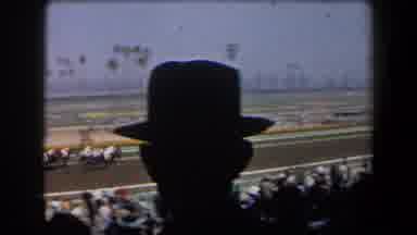 California (1958): Crowd Watches Horse Race From Grandstands Palm Trees In Infield