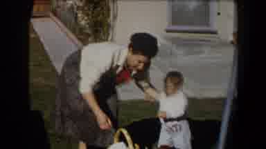 California (1958): Woman Wearing White Sweater Grabs White Item From Brown Basket
