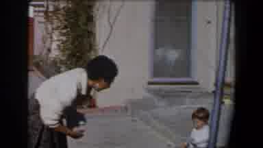 California (1958): A Nanny Taking Some Clothes Of The Ground And Watching A Little