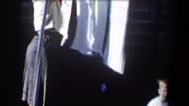 California (1958): Woman Wearing White Shirt Hangs White Items On Clothesline On A