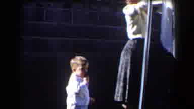 California (1958): Small Boy Handing Woman A Clothes Pin That She Uses To Pin A