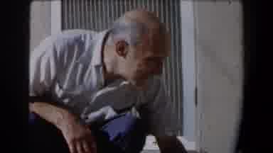 California (1958): A Man Dressed In A Suit And Tie Holds A Struggling Male Toddler