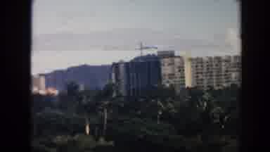 Hawaii (1961): View Of White Building And Green Trees On A Sunny Day