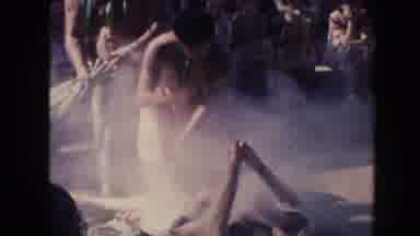 Hawaii (1961): Tribe Cooks The Inside Of A Pig As Smoke Comes Out And People Watch